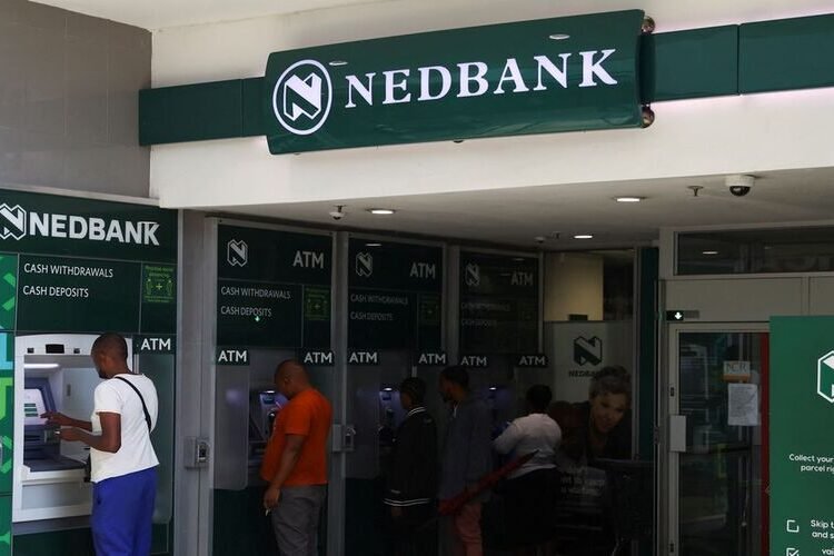 Customers perform transactions on Nedbank automated teller machine (ATM) at the Trade Route Mall, in Lenasia outside Johannesburg, South Africa, February 8, 2023. REUTERS/Siphiwe Sibeko